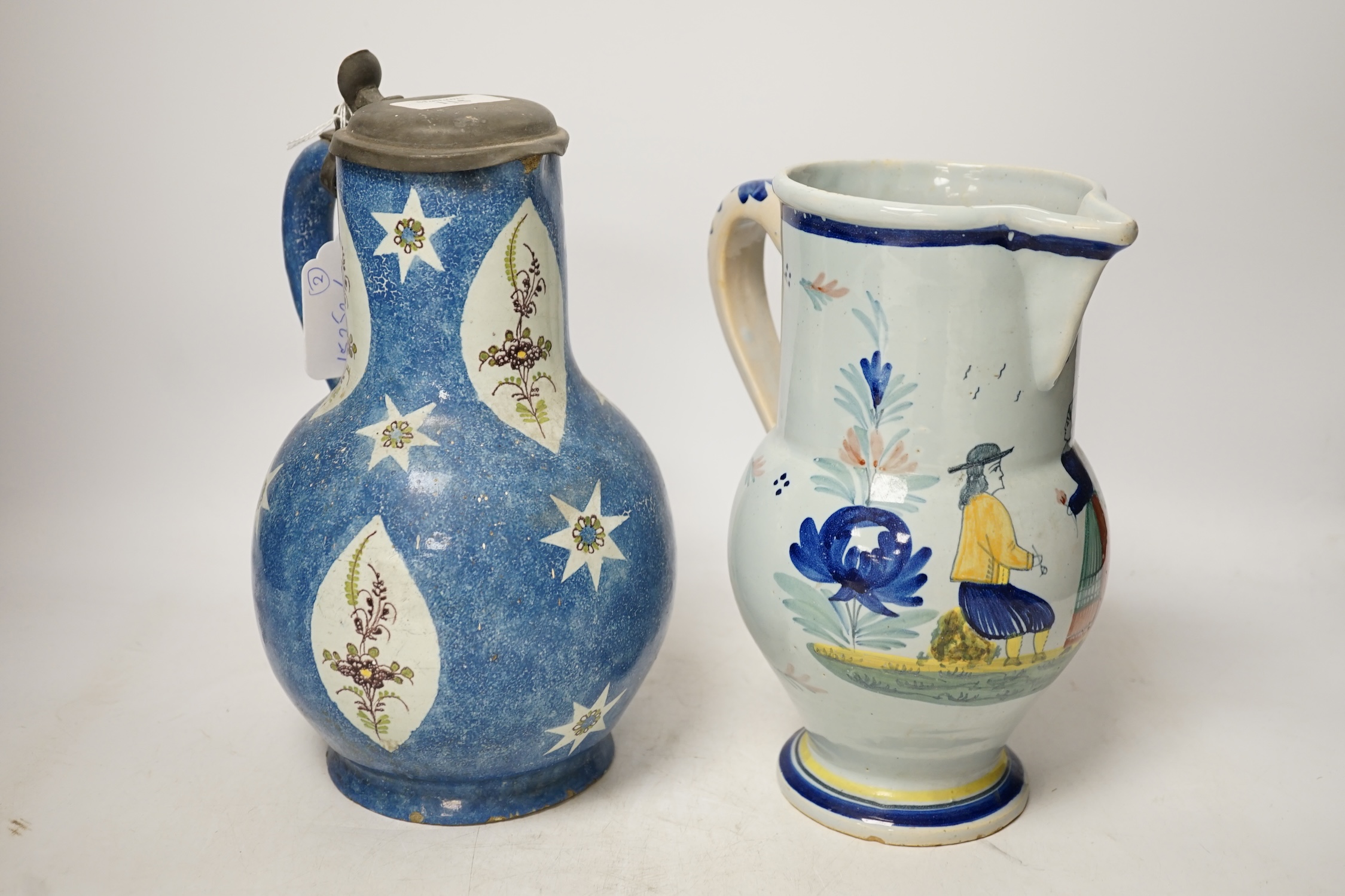 An 18th / 19th century Brussels faience jug and a French Quimper faience pottery jug, largest 25cm high. Condition - fair to good